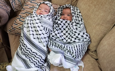 Family’s Bittersweet Moment: Holding Twins Aloft at Father’s Funeral
